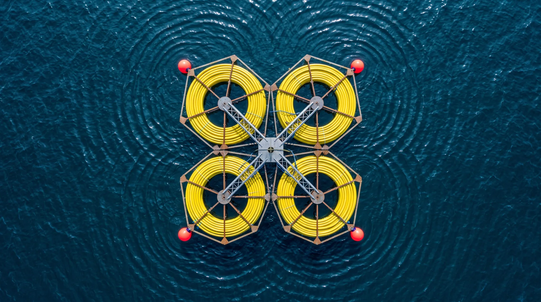 Top-down view of subsea cable coils floating on open water